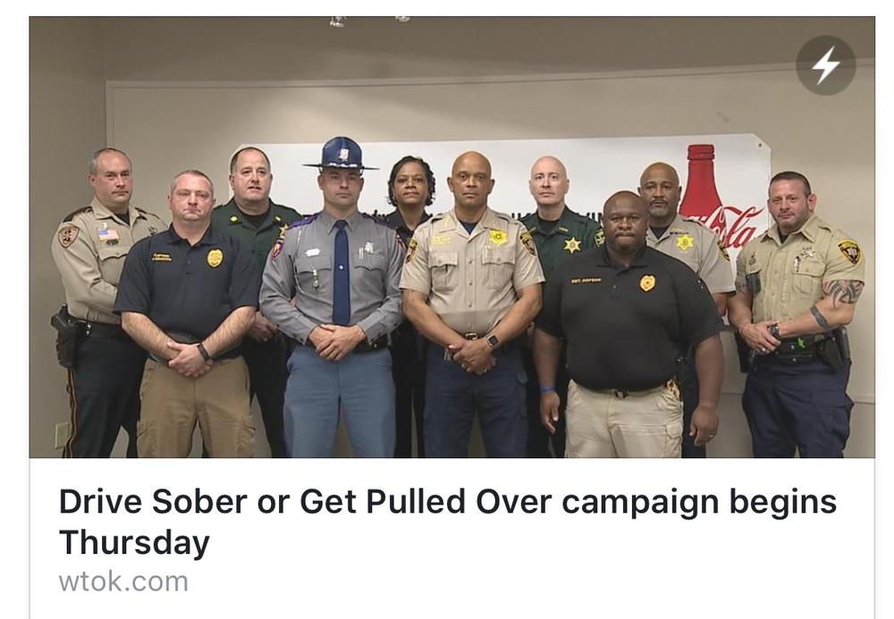 Sheriffs office staff standing with language beneath photo saying "Drive Sober or Get Pulled Over campaign begins Thursday"