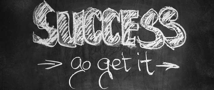 the words Success, Go Get It, written in chalk on black background